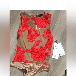 Iris Nude body suit with red details size large brand new with tags